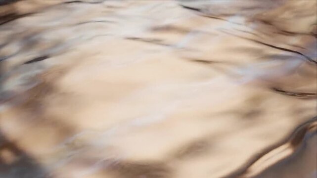 Abstract beige brown background with flowing blurred water texture, soft organic movement, calm cream and gray reflections, tranquil atmospheric surface and artistic design pattern for visual projects