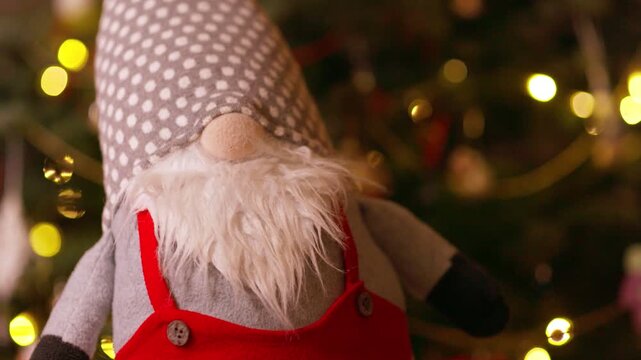 Cute Christmas Gnome Doll Against Blurry Holiday Lights Background