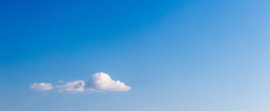 Single white cloud in clear blue sky