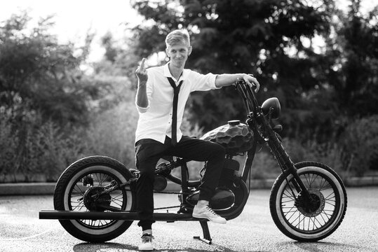 A couple of newlywed freaks on a black custom bike