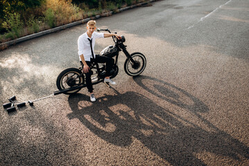 Fototapeta premium A couple of newlywed freaks on a black custom bike