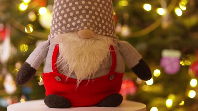 Christmas Gnome Toy Rotating in Front of Blurry Festive Tree Lights