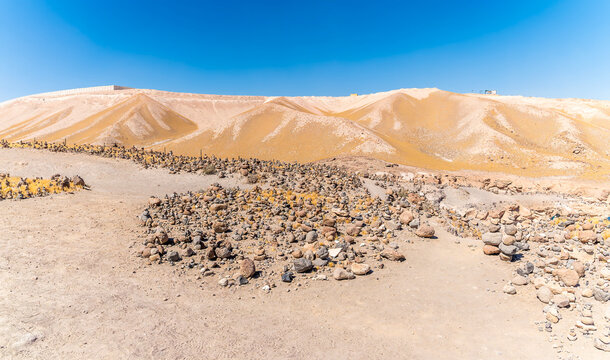 A view back past a field of cairns towards the exit from the Culebrillas canyon close to Arequipa, Peru in the dry season