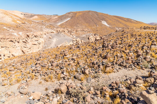 A view past cairns at the exit from the Culebrillas canyon close to Arequipa, Peru in the dry season
