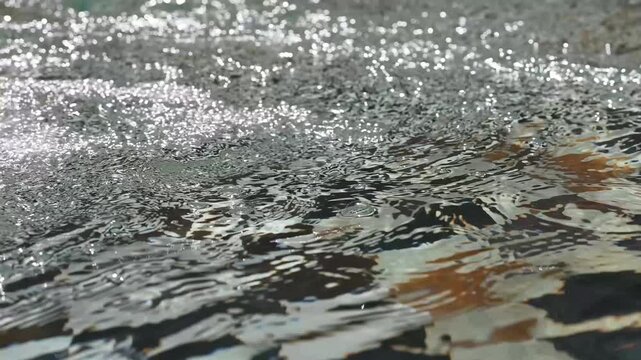 Sparkling Sunlight Ripples and Bubbles in a Traditional Moroccan Fountain Basin