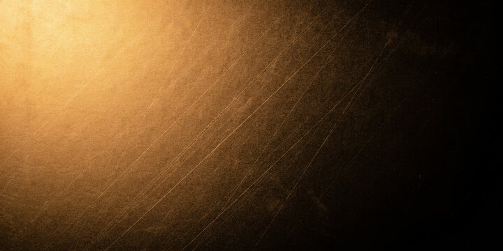 Gold scratched metallic texture background with warm light vignette.