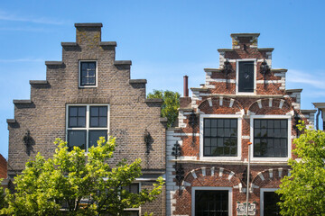 Fototapeta premium Typical Dutch stepped gable houses in the old town of Brielle, The Netherlands. Historic buildings.