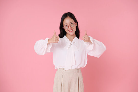 Smiling businesswoman giving double thumbs up expressing approval confidence success satisfaction positive feedback achievement recommendation and professional optimism.