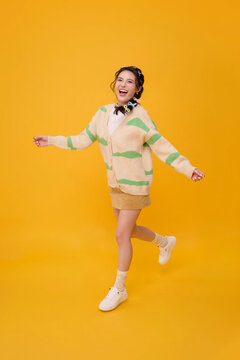 Young woman walking with arms open and smiling expressing joyful freedom positive energy confidence carefree lifestyle optimism happiness and youthful self expression.