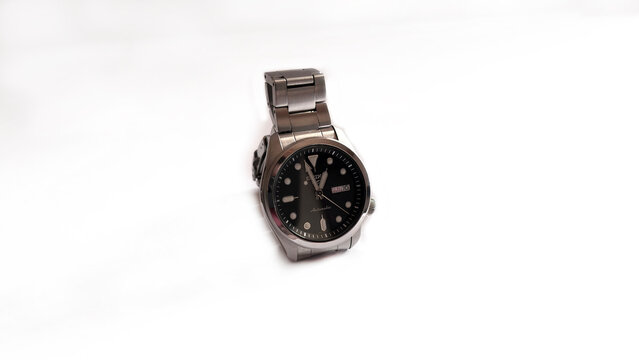 Kediri, East Java, Indonesia &ndash; August 21, 2026: Metallic Wristwatch with Dark Dial Displayed on Red Velvet Case