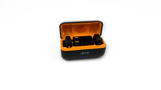 Kediri, East Java, Indonesia &ndash; August 21, 2026: Black and Orange Wireless Microphone Case with Components Displayed on White Background