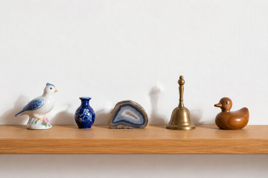 Wooden shelf with small knickknacks, collection and display concept