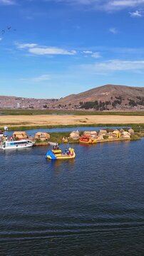 Aerial drone view of the floating Uros Islands on Lake Titicaca. The highest navigable lake in the world, located near Puno, Peru, South America. Popular travel destination.	