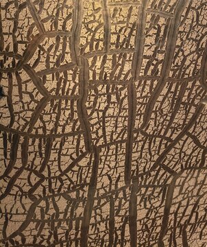 Abstract golden craquelure texture background with cracked vintage paint effect, macro detail