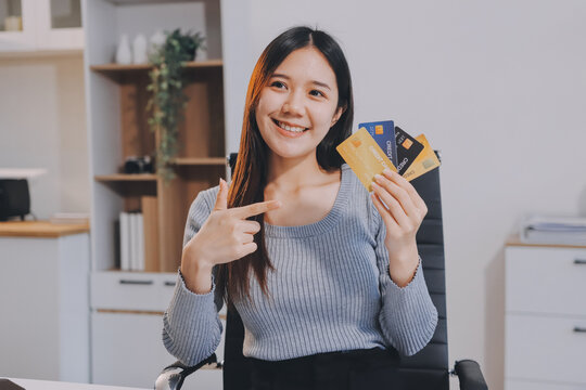 Young Asian business woman using smartphone and credit card for online shopping. Online Payment.