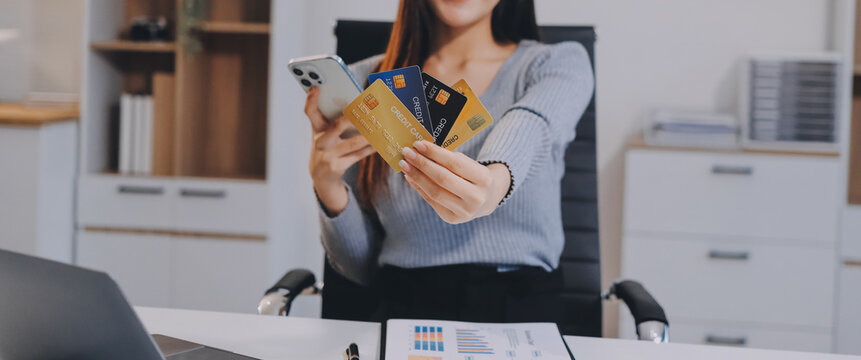 Young Asian business woman using smartphone and credit card for online shopping. Online Payment.