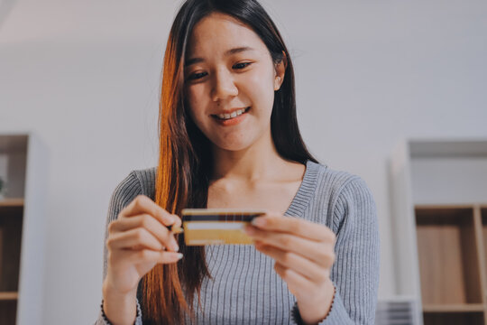 Young Asian business woman using smartphone and credit card for online shopping. Online Payment.