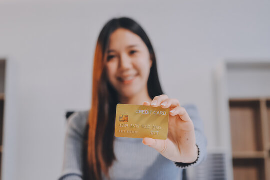 Young Asian business woman using smartphone and credit card for online shopping. Online Payment.
