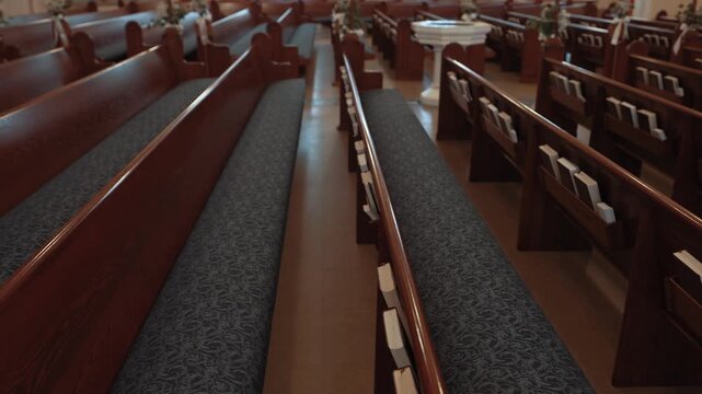 Empty Church Sanctuary with Rows of Wooden Pews and Hymnals
