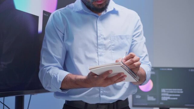 Software Developer reading note report and verifying coding on screen computer technology at office. Programmer working writing code analysis system artificial intelligence. Software engineer present