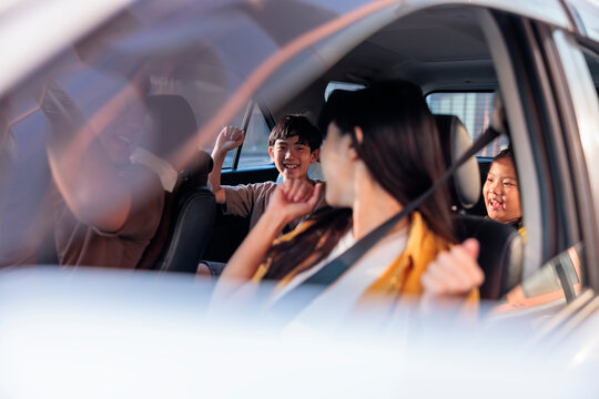 A cheerful family enjoying a fun car ride together.