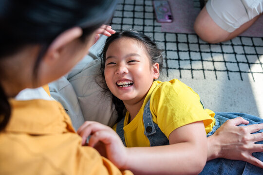 A joyful moment between a young girl and mother