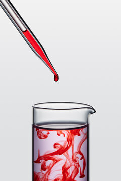 adding red liquid to the flask