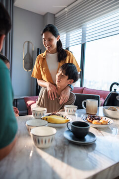 A mother and son share a warm morning breakfast.