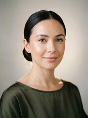 Fototapeta premium Close up portrait of a young elegant woman with dark hair and a serene expression
