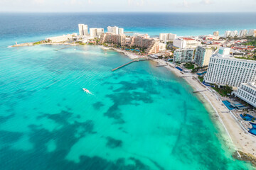 Naklejka premium Aerial panoramic view of Cancun beach and city hotel zone in Mexico. Caribbean coast landscape of Mexican resort with beach Playa Caracol and Kukulcan road. Riviera Maya in Quintana roo region on
