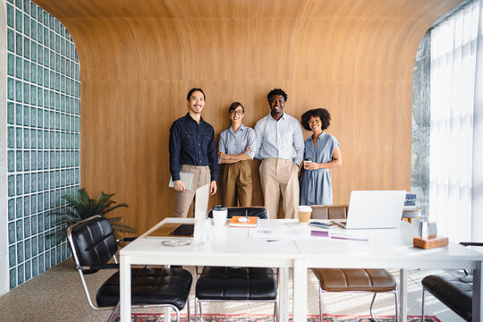Group of Four People Standing in Office Space During Work Hours