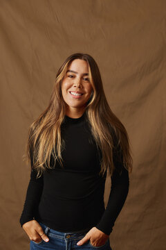 Smiling young woman with long hair and freckles