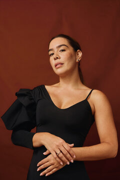Woman posing in elegant formalwear during a studio session