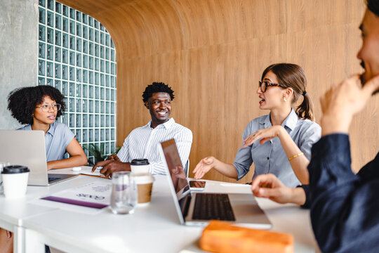 Team Members Discuss Ideas During a Meeting in a Modern Office