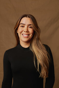 Young woman smiling, expressing happiness and positive emotion