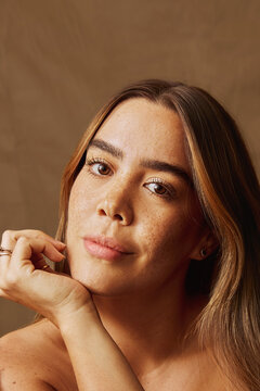 Portrait of a young latin woman with natural beauty and freckles