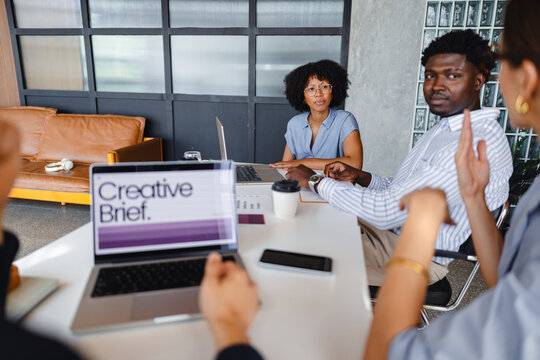 Team Members Discuss a Project in a Modern Office Setting