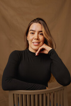 Young woman smiling with confidence posing in studio