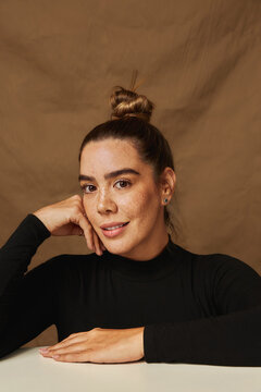 Woman with freckles smiling posing confidently