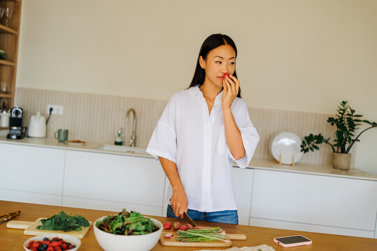 Woman preparing healthy food enjoying fresh ingredients