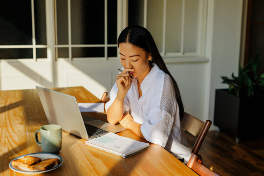 Woman working from home planning for future tasks