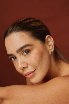 Woman with freckles looking confidently at camera