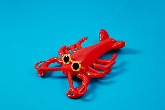 diagonal view of an inflatable lobster with flower-shaped sunglasses