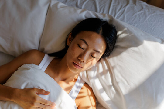 Woman person sleeping peacefully in comfortable bed