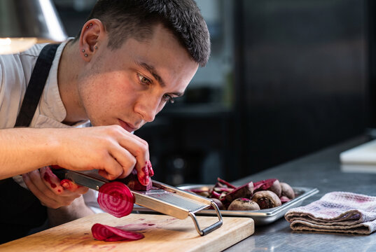 Beetroot slicing with mandoline in a professional kitchen