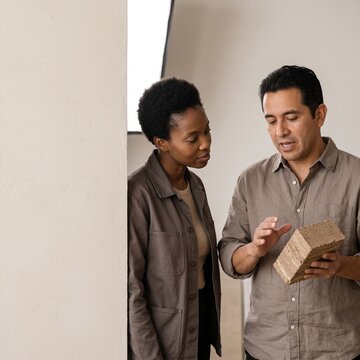 Architect and designer examining a sustainable eco friendly building brick sample in a bright studio