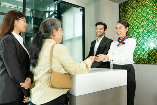 Professional staff assist a customer at a modern reception desk creating a welcoming experience for business service hospitality and client support.