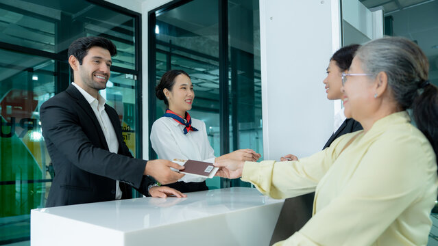 A senior customer interacts with professional staff at an office reception while receiving a document highlighting personal service business support and professional care.