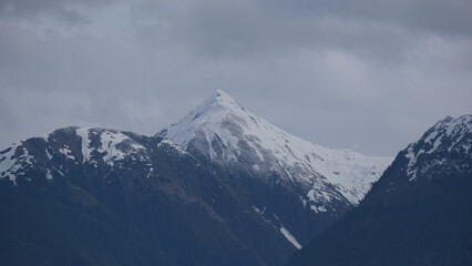 Fototapeta premium Breathtaking Alaska mountain glacier range view seen from outdoor deck of cruise ship liner sailing the Inside Passage transit with spectacular landscape wilderness scenery