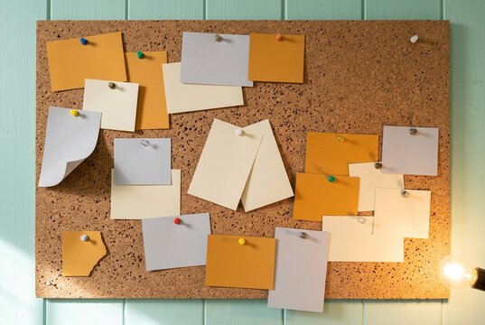 Pinboard planning with sticky notes on a corkboard for office ideas